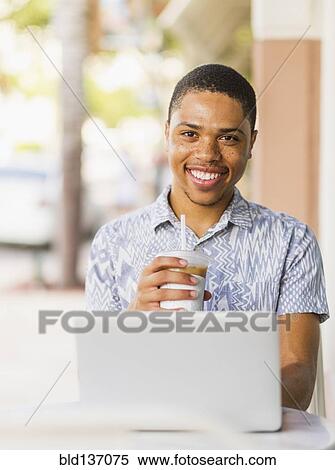 African American man using laptop in cafe View Large Photo Image Stock Photography - African American man using laptop in cafe. Fotosearch