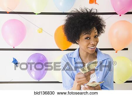 African American woman counting money at balloon wall View Large Photo Image Stock Image - African American woman counting money at balloon wall. Fotosearch