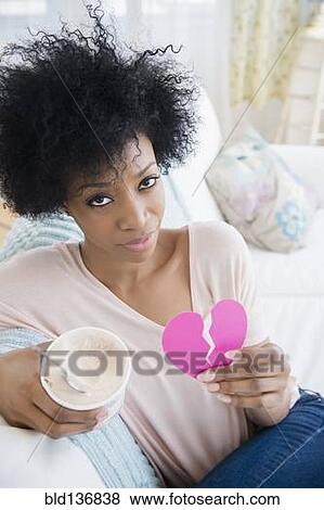 African American woman holding broken heart and ice cream View Large Photo Image Stock Photo - African American woman holding broken heart and ice cream. Fotosearch