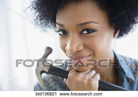 African American woman holding hammer View Large Photo Image Stock Image - African American woman holding hammer. Fotosearch