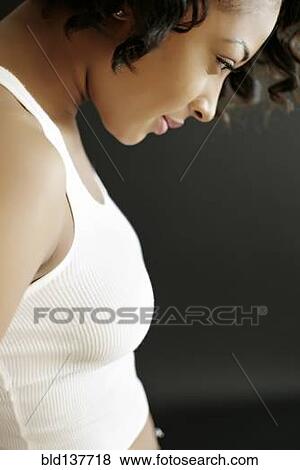 Stock Photo - African American woman looking down. Fotosearch