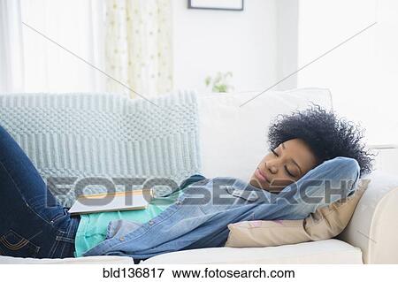 African American woman napping on sofa View Large Photo Image Stock Photo - African American woman napping on sofa. Fotosearch