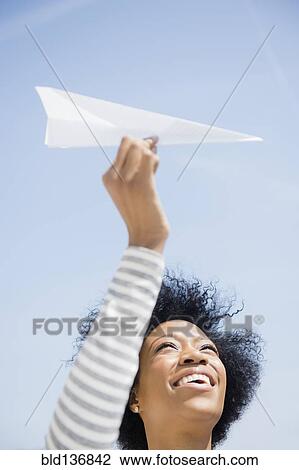 African American woman throwing paper airplane View Large Photo Image Stock Image - African American woman throwing paper airplane. Fotosearch