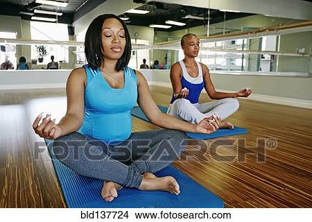 African American women meditating in yoga studio View Large Photo Image Picture - African American women meditating in yoga studio. Fotosearch
