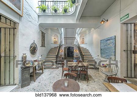 Stock Photo - Balcony and staircase in traditional coffee shop. Fotosearch