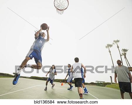 Picture - Basketball team doing drills at practice. Fotosearch