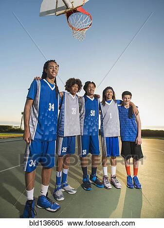 Basketball team posing on court View Large Photo Image Stock Photography - Basketball team posing on court. Fotosearch
