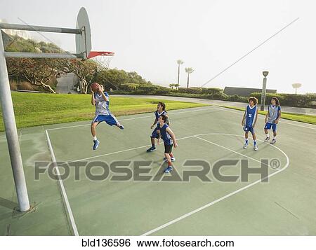 Basketball teams playing on court View Large Photo Image Stock Photograph - Basketball teams playing on court. Fotosearch