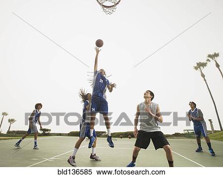 Stock Photography - Basketball teams playing on court. Fotosearch