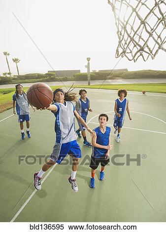 Stock Photography - Basketball teams playing on court. Fotosearch
