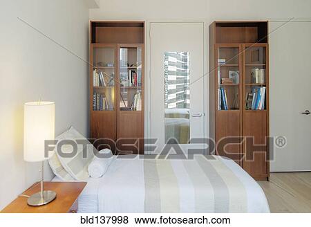 Bed, bookshelves and bedside table in bedroom View Large Photo Image Stock Photo - Bed, bookshelves and bedside table in bedroom. Fotosearch