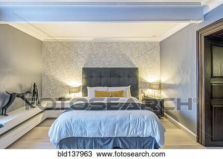 Bed, lighting and art in modern hotel room View Large Photo Image Stock Image - Bed, lighting and art in modern hotel room. Fotosearch