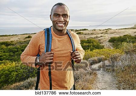 Black man hiking on rural path View Large Photo Image Stock Photograph - Black man hiking on rural path. Fotosearch