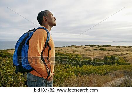 Black man overlooking rural hillside View Large Photo Image Stock Image - Black man overlooking rural hillside. Fotosearch