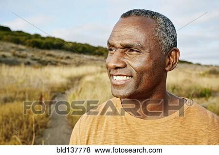Black man standing on rural path View Large Photo Image Stock Photo - Black man standing on rural path. Fotosearch