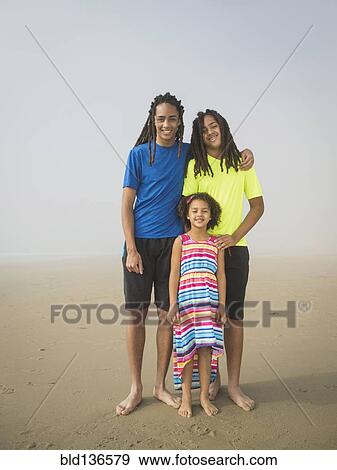 Black siblings smiling on beach View Large Photo Image Stock Photo - Black siblings smiling on beach. Fotosearch