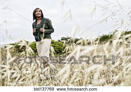 Black woman hiking on rural hillside View Large Photo Image Stock Photo - Black woman hiking on rural hillside. Fotosearch