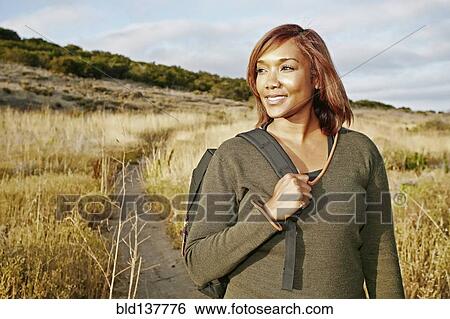 Black woman hiking on rural path View Large Photo Image Stock Photograph - Black woman hiking on rural path. Fotosearch