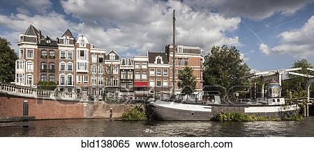 Boat mooring on urban canal, Amsterdam, Holland View Large Photo Image Stock Photography - Boat mooring on urban canal, Amsterdam, Holland. Fotosearch