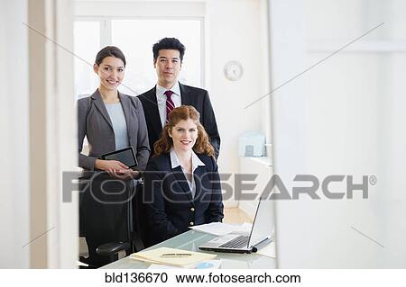 Business people smiling in office View Large Photo Image Stock Image - Business people smiling in office. Fotosearch