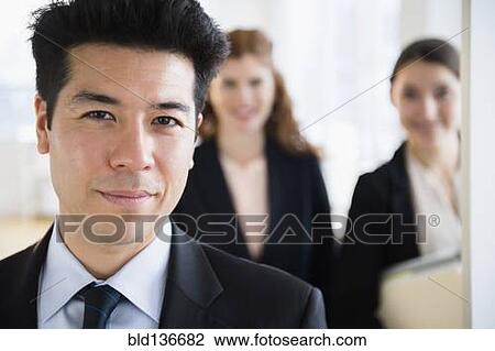 Business people smiling in office View Large Photo Image Stock Image - Business people smiling in office. Fotosearch