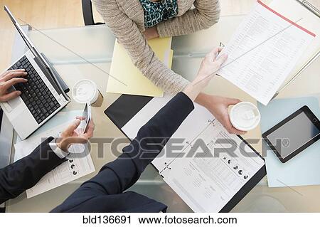 Stock Image - Business people talking in meeting. Fotosearch