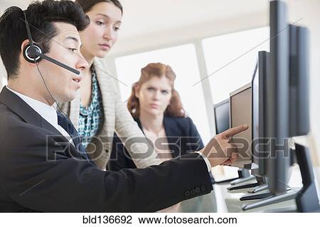 Stock Image - Business people talking in meeting. Fotosearch