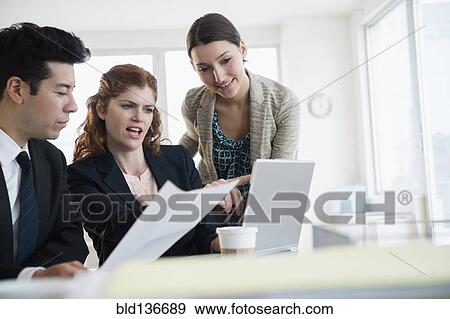 Stock Photo - Business people talking in meeting. Fotosearch