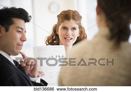 Stock Photograph - Business people talking in meeting. Fotosearch