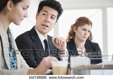 Stock Photography - Business people talking in meeting. Fotosearch