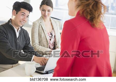 Stock Photo - Business people talking in office. Fotosearch
