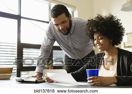 Stock Photo - Business people working together in office. Fotosearch