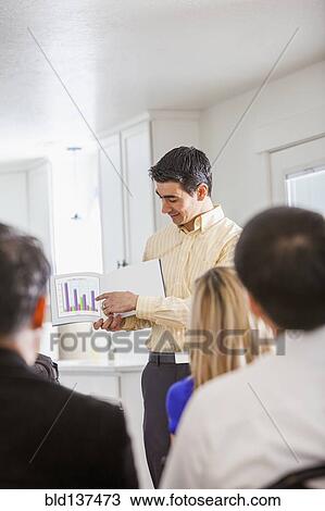 Businessman giving presentation to colleagues View Large Photo Image Stock Image - Businessman giving presentation to colleagues. Fotosearch