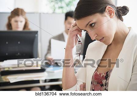 Businesswoman scratching her head in office View Large Photo Image Picture - Businesswoman scratching her head in office. Fotosearch