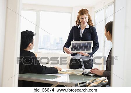 Picture - Businesswoman talking in meeting. Fotosearch
