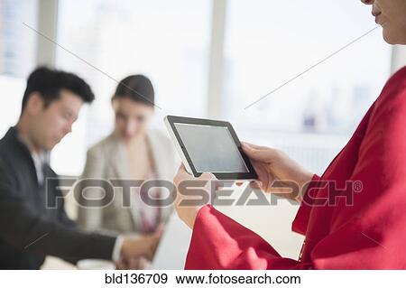 Stock Photo - Businesswoman using digital tablet in office. Fotosearch