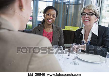 Businesswomen talking in restaurant View Large Photo Image Stock Photograph - Businesswomen talking in restaurant. Fotosearch