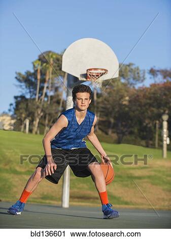 Caucasian basketball player dribbling ball on court View Large Photo Image Stock Image - Caucasian basketball player dribbling ball on court. Fotosearch