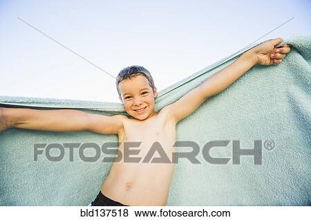 Caucasian boy playing with towel outdoors View Large Photo Image Stock Photo - Caucasian boy playing with towel outdoors. Fotosearch