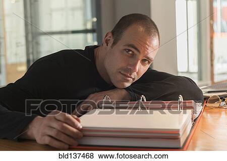 Caucasian businessman reading at desk View Large Photo Image Stock Photo - Caucasian businessman reading at desk. Fotosearch