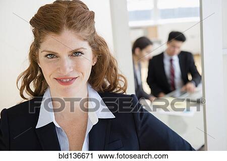 Caucasian businesswoman smiling in office View Large Photo Image Stock Image - Caucasian businesswoman smiling in office. Fotosearch
