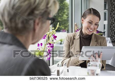 Stock Photography - Caucasian businesswomen working in restaurant. Fotosearch