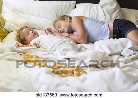 Caucasian girl and toddler brother asleep on bed View Large Photo Image Stock Image - Caucasian girl and toddler brother asleep on bed. Fotosearch