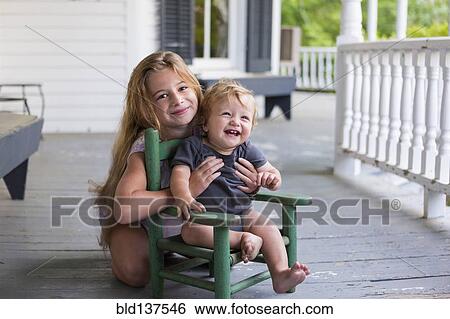 Caucasian girl and toddler brother playing on porch View Large Photo Image Stock Photograph - Caucasian girl and toddler brother playing on porch. Fotosearch