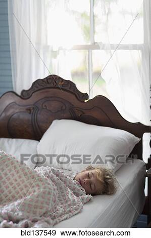Caucasian girl asleep in bed View Large Photo Image Stock Photo - Caucasian girl asleep in bed. Fotosearch