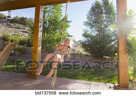 Caucasian girl playing on rope swing View Large Photo Image Stock Photo - Caucasian girl playing on rope swing. Fotosearch