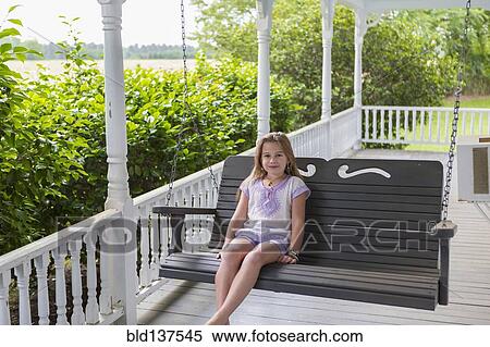 Caucasian girl relaxing in swing on porch View Large Photo Image Stock Photography - Caucasian girl relaxing in swing on porch. Fotosearch