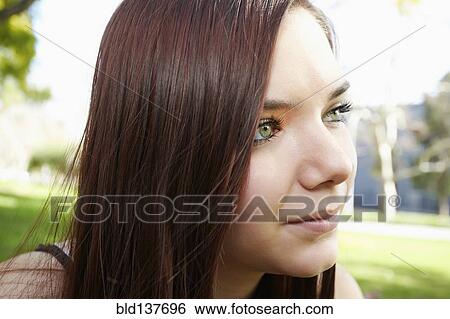 Stock Photograph - Caucasian girl sitting outdoors. Fotosearch