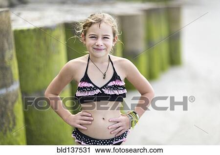 Caucasian girl wearing bikini on beach View Large Photo Image Stock Image - Caucasian girl wearing bikini on beach. Fotosearch