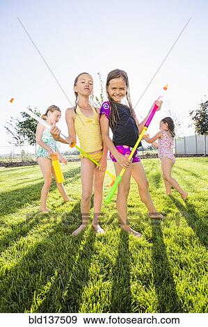 Caucasian girls playing in backyard View Large Photo Image Stock Photo - Caucasian girls playing in backyard. Fotosearch